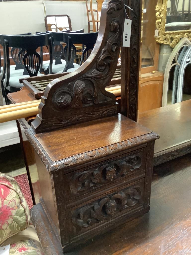 A late 19th century Flemish carveed oak kneehole dressing table, width 136cm depth 56cm height 183cm